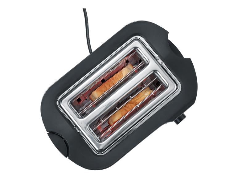 Zwarte broodrooster met twee sneetjes toast erin, van bovenaf