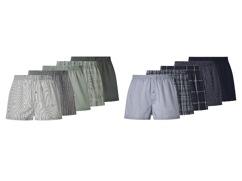 Een set van 10 herenboxershorts in diverse groene, grijze en blauwe kleuren en patronen.
