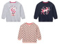 Drie longsleeve shirts met prints: een met polkadots, een met een paard en een met een snoepmachine.