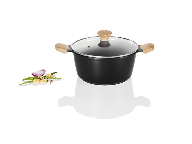 Zwarte pan met glazen deksel en houten handgrepen.