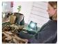 Vrouw gebruikt LIVARNO® werklamp „The Portable” voor tuinieren.