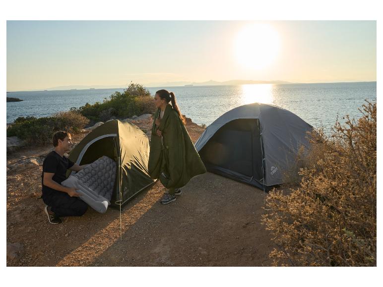 Twee Crivit tenten en een campingmatras aan een zonnige kust.