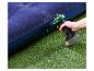 Elektrische luchtpomp blaast een blauw opblaasbaar matras op groen gras op.