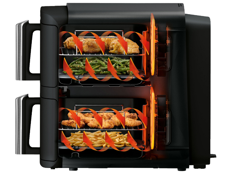 Airfryer met kip, friet en sperziebonen, die de heteluchtcirculatie toont.