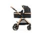 Zwarte en gouden kinderwagen met reiswieg en verstelbare handgreep