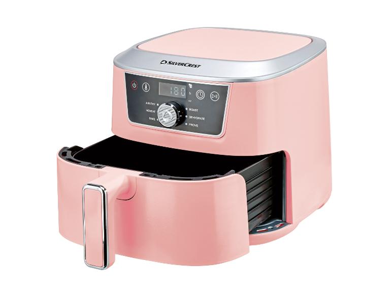 Roze heteluchtfriteuse met open lade en digitaal bedieningspaneel.