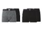 Twee verpakkingen Looks boxershorts in grijs en zwart.