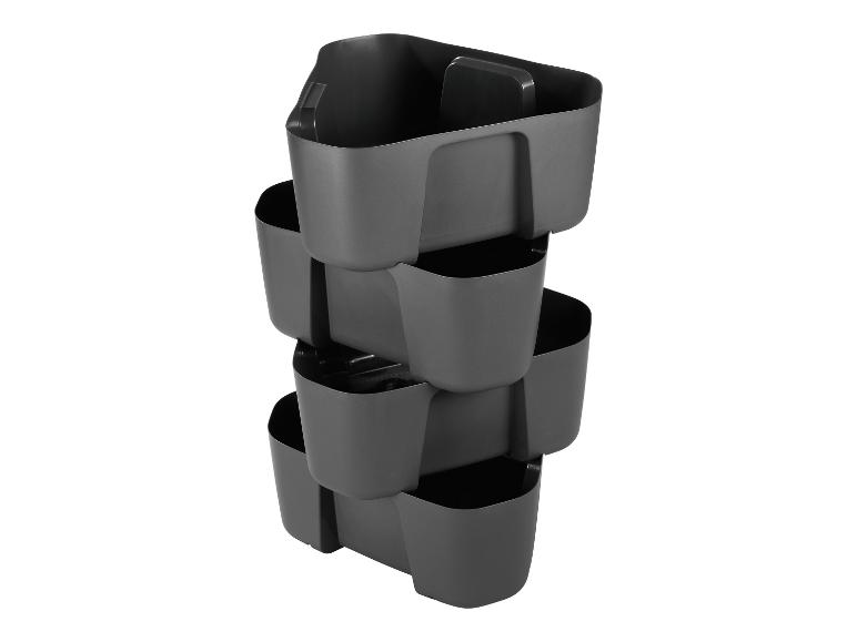 Grijze stapelbare verticale plantenbak voor planten of kruiden.