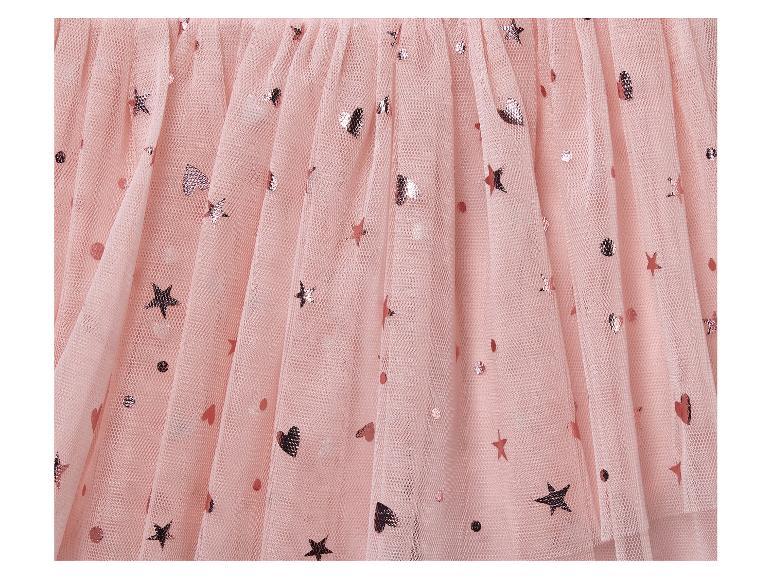 Een roze tule rok met gouden sterren en stippen.