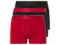 Drie boxershorts: één rood en twee zwart.