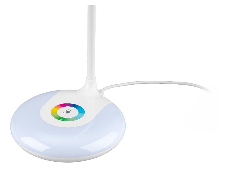 Witte bureaulamp met verlichte ronde voet en een kleurrijke cirkel.
