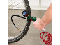 Een persoon pompt een fietsband op met een digitale bandenpomp en drukmeter.