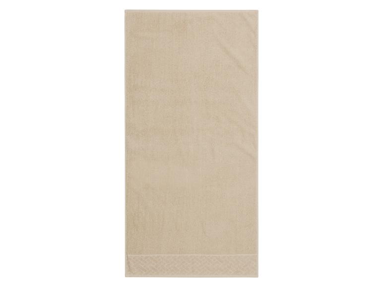 Beige handdoek met patroonrand
