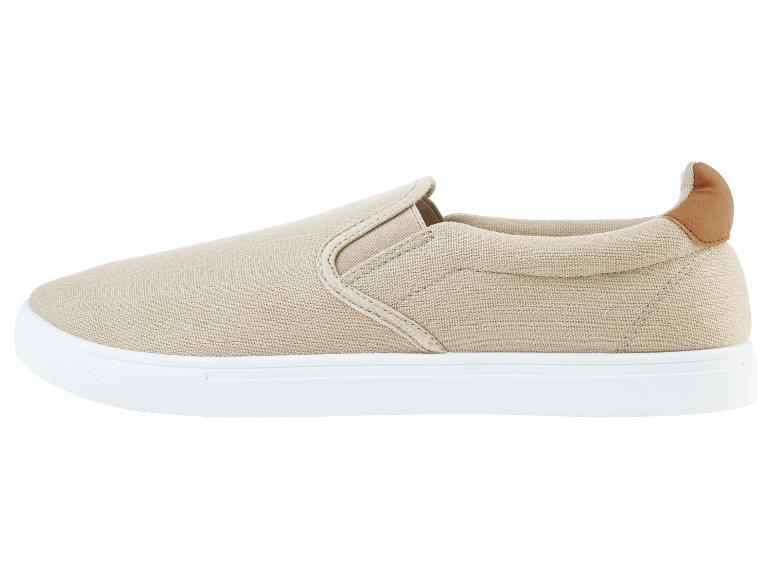 Beige canvas slip-on sneakers.