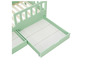 Een mintgroen kinderbed met een uittrekbare lade.
