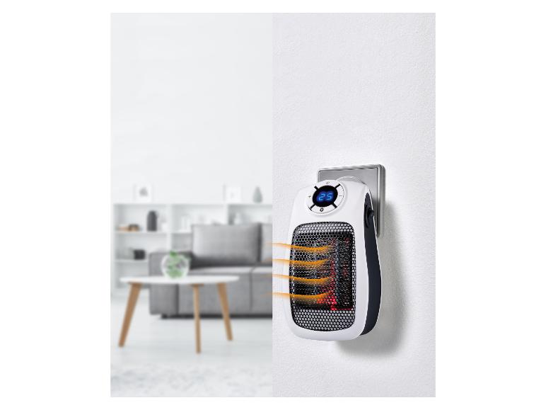 Draagbare stekkerverwarming met digitaal display in een modern huis