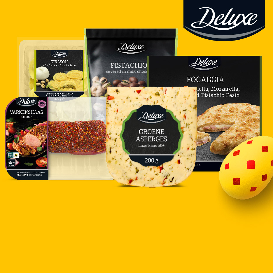 Een assortiment van luxe voedingsproducten, waaronder kaas met groene asperges, varkenshaas, pistachenoten en focaccia.