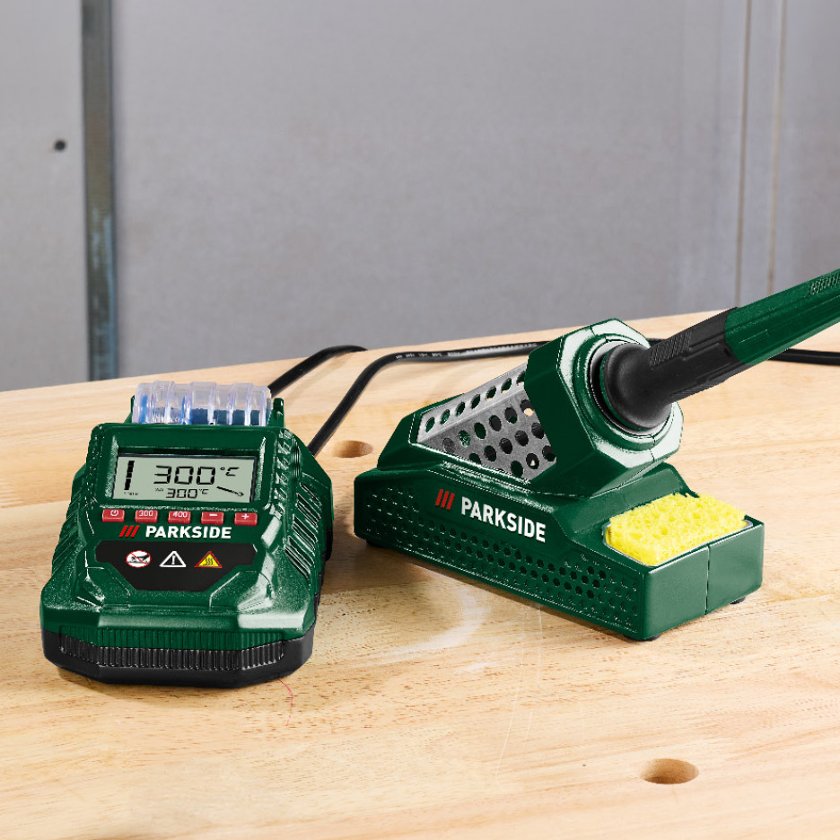 Soldeerstation met digitale temperatuurregeling en soldeerbout op een houten werkbank.