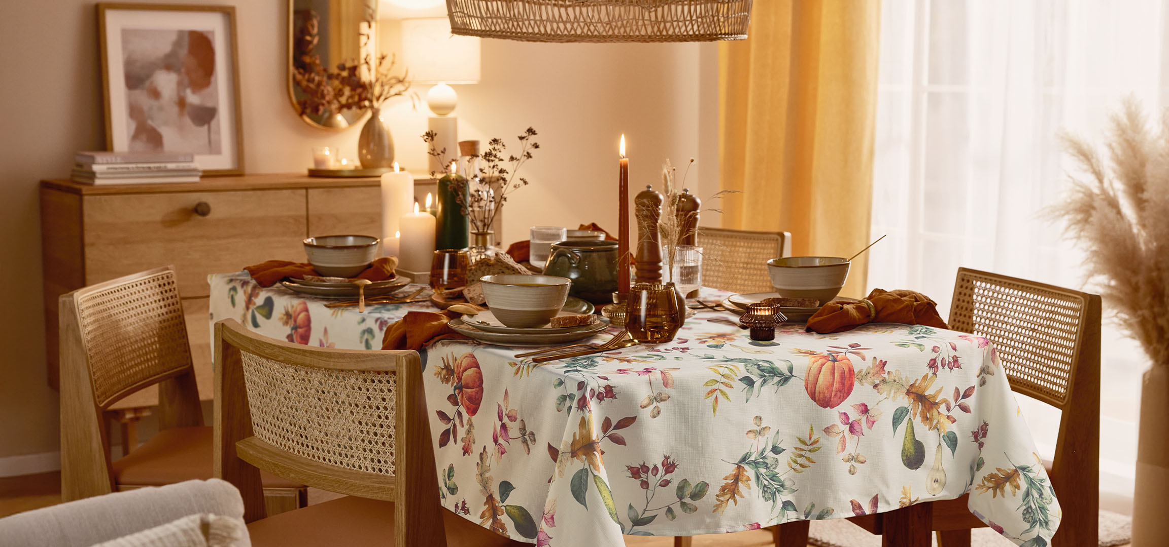 Eetkamer met een tafel gedekt voor een maaltijd, met een bloemig tafelkleed en warme verlichting.